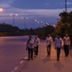 Migrant workers walk along a road to return to their villages